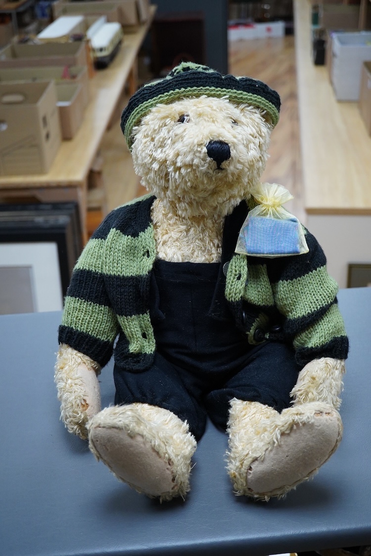 A Steiff artificial silk Teddy bear, (5650.2), jointed blonde body, stitched snout and glass eyes, button in ear, with related book and papers, bear 50cm